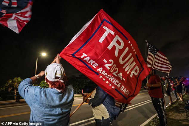 Trump supporters wave MAGA flags near his Mar-a-Lago resort in Palm Beach, Florida.