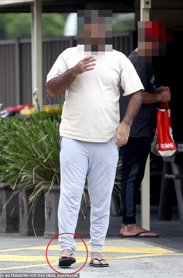 Pictured is a former detainee wearing an ankle monitor who was released after last year's High Court decision that indefinite detention is unlawful.