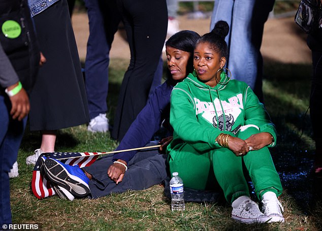 Supporters of Vice President Kamala Harris sit in the Howard University quad and watch as election results point to a possible victory for Donald Trump.