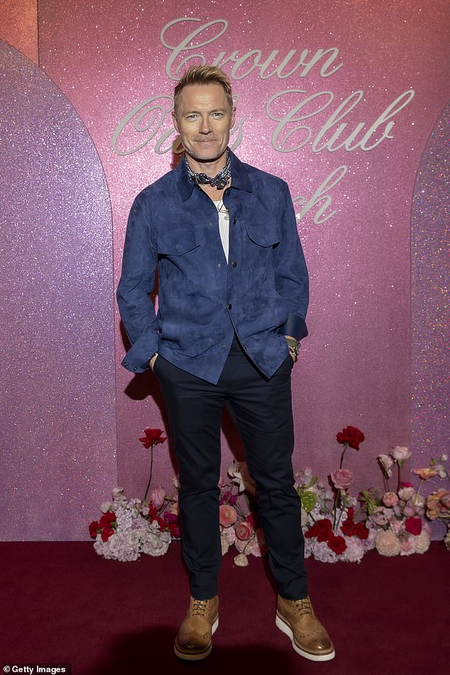 Ronan Keating put on a stylish display in a blue velvet button-down shirt and navy trousers.