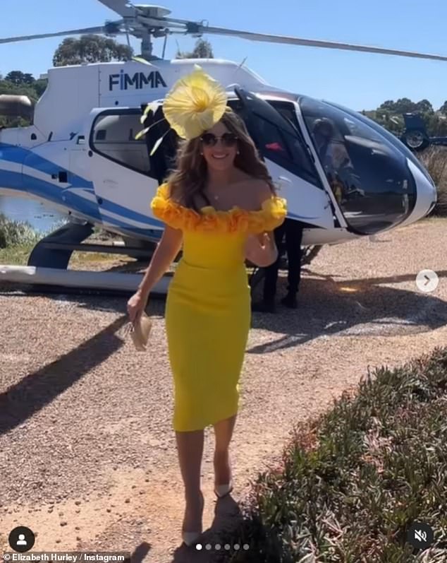 The model gave herself a few extra inches in a pair of cream heels and wore a huge floral headdress as she arrived at the racecourse by helicopter.