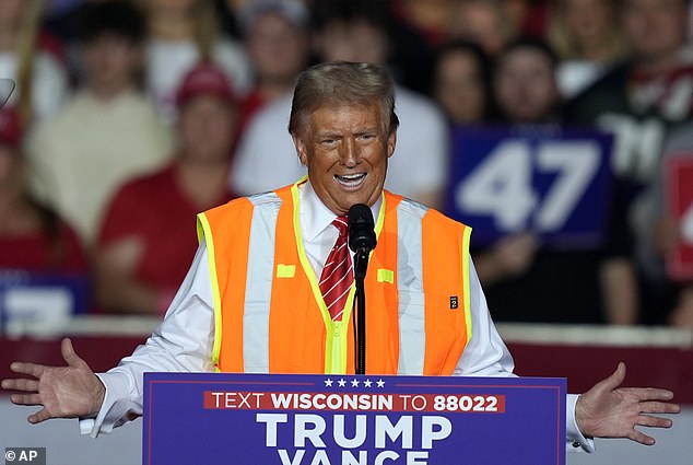 The former president donned a neon garbage truck driver's vest on stage at his rally in Green Bay.