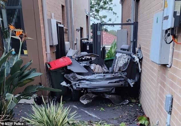 The car broke in half and the rear end (pictured) ended up on the side of a house.