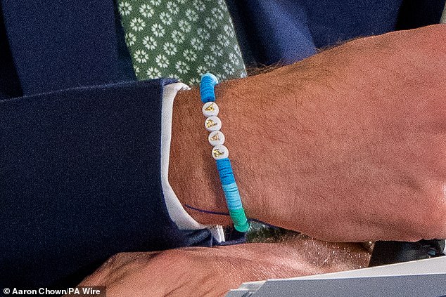 Prince William yesterday, wearing a 'Dad' friendship bracelet made by Princess Charlotte