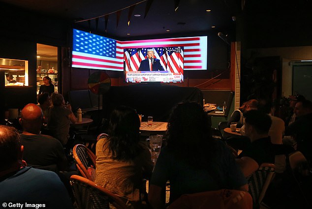 Pub-goers in Sydney watched the results roll in, some shedding tears as Trump gained ground in the polls (pictured, audience for a live broadcast of the election at Sydney's Kent Street Hotel).