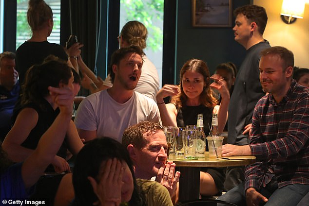 As of 3:45 a.m. Wednesday in Washington, Harris' camp had not reacted to the results as the Associated Press waited to make the final call (pictured, audience for a live broadcast of the election in Sydney).