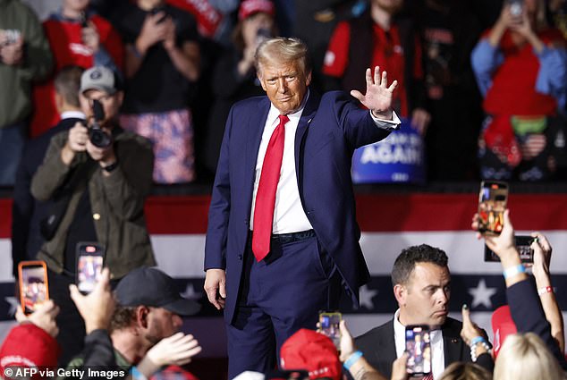 Former US president and Republican presidential candidate Donald Trump greets supporters at the end of a campaign rally on November 5.