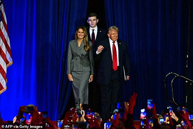 Donald Trump arrives at an election night event Wednesday with former first lady Melania Trump and his son Barron Trump.