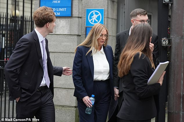 Nikita Ni Laimhin (centre) outside the High Court in Dublin on Tuesday, where mixed martial arts fighter Conor McGregor appears in a personal injury case against him.