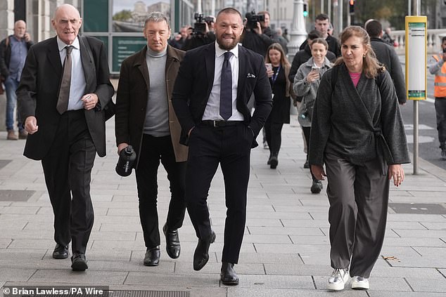 Conor McGregor (second right) with his father Tony McGregor (second left) outside the High Court in Dublin on November 6.