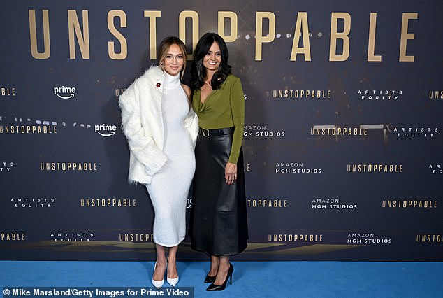 On Tuesday, the Emmy-nominated producer showed off the Basic Instinct reality in a white Magda Butrym dress while posing with Judy Robles (right) at the UK premiere of Unstoppable.