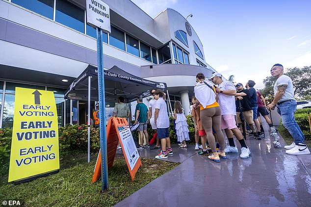 Trump made huge gains among Latino voters: above, voters in Miami wait to cast their vote