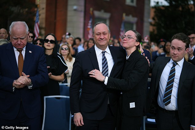 The 60-year-old was seen being hugged by his daughter Ella as a somber-looking Governor Walz bowed his head.