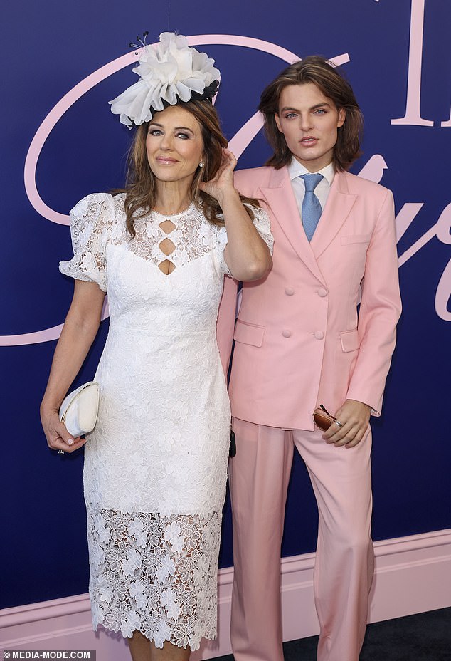 Damian cut a dapper figure in a pastel pink two-piece suit,