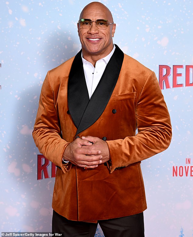 Meanwhile, Dwayne was every inch the Hollywood heartthrob in a rust-colored jacket that appeared to be made of velvet or velvet.