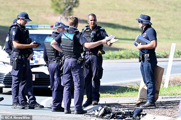 Queensland police are investigating whether the teenager allegedly ran a red light before the Audi crashed into the Toyota sedan (pictured, police at the scene)