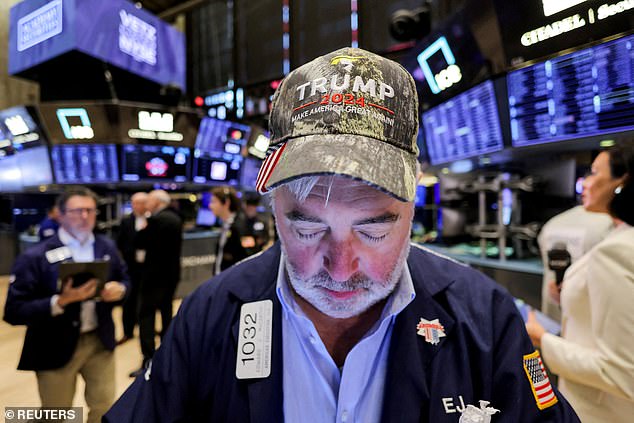 A trader wears a hat in support of Republican Donald Trump, after he won the US presidential election, at the New York Stock Exchange in New York City, the United States, on November 6, 2024.