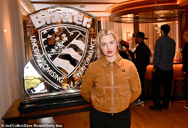 The blonde beauty was in good spirits as she posed at the fashion event.