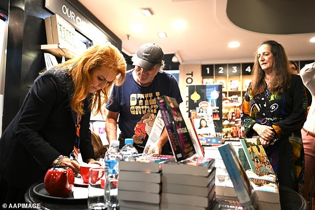 Sarah was more than happy to oblige, enthusiastically scribbling her name inside numerous copies of the book as avid readers crowded around her.