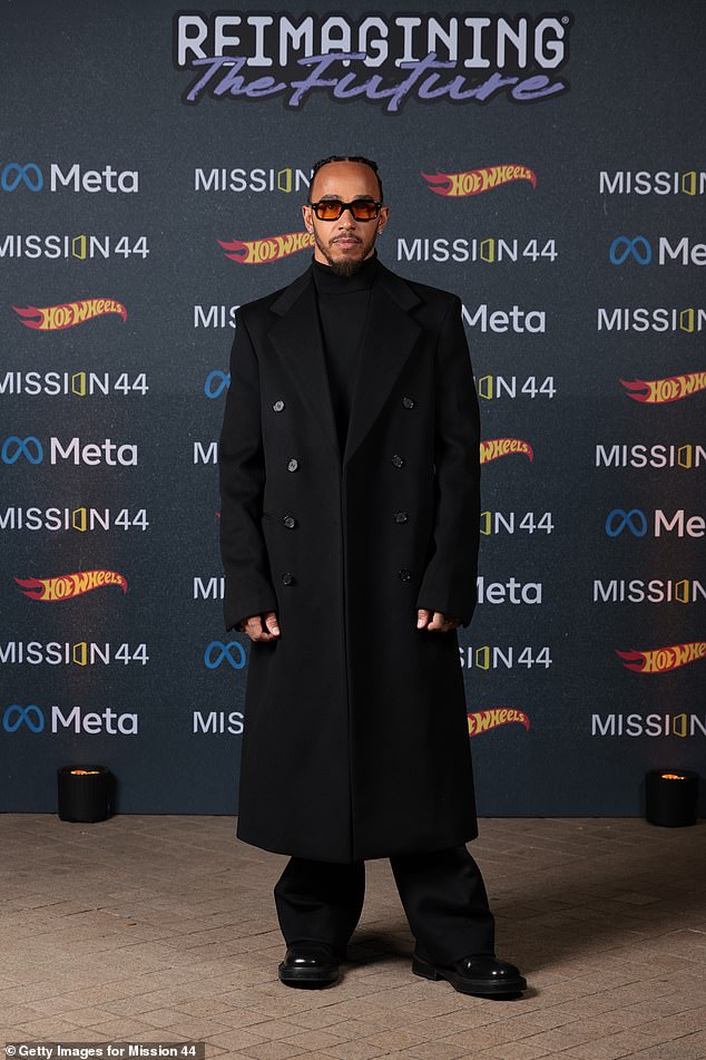 Lewis looked stylish in a double-breasted trench coat which he paired with a turtleneck.