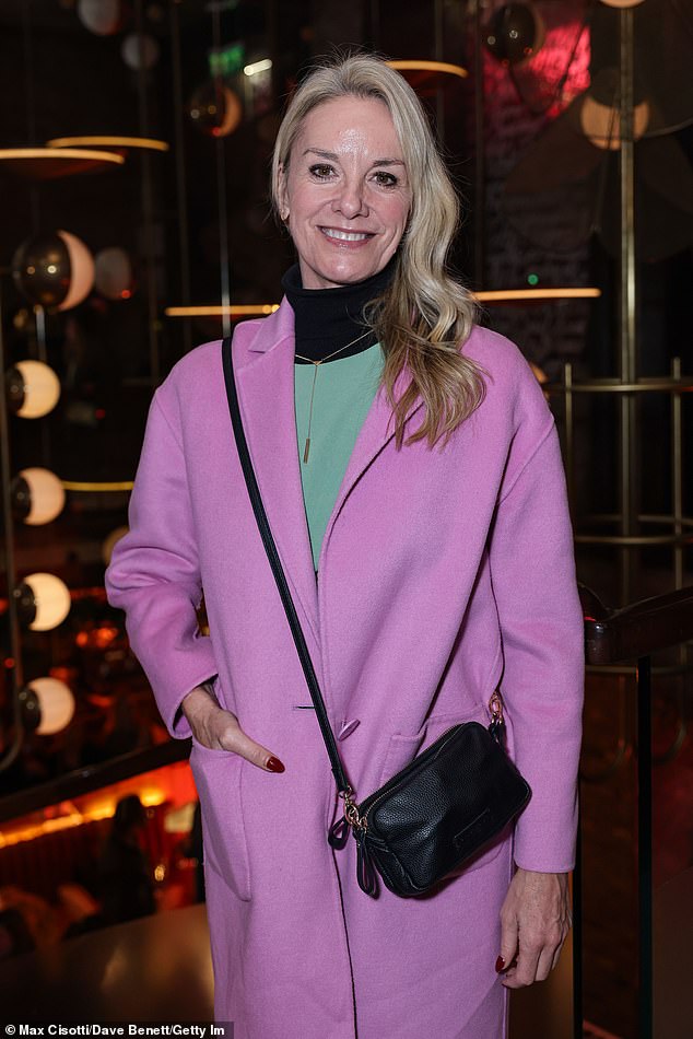 Tamzin donned a green jumpsuit over a black polo shirt, paired with a chic pink coat.