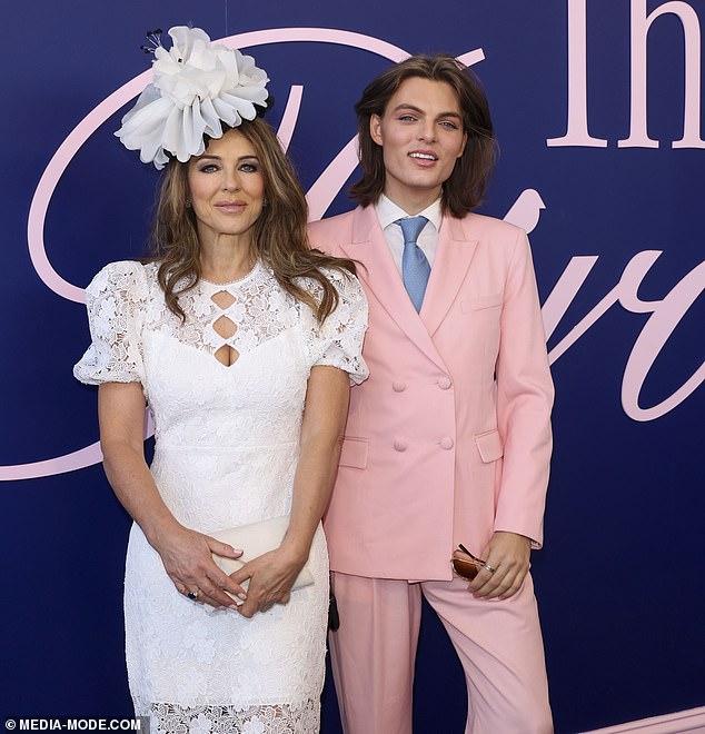 Liz embraced the race day look as she placed a huge white floral headpiece in her brunette locks, making sure to turn heads with her chic ensemble.