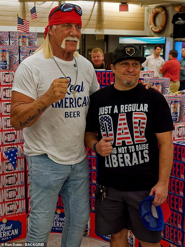 Hogan, whose real name is Terry Gene Bollea, also sported his cross-body chain, statement watch and wedding ring as he waved and posed for excited fans in the store.