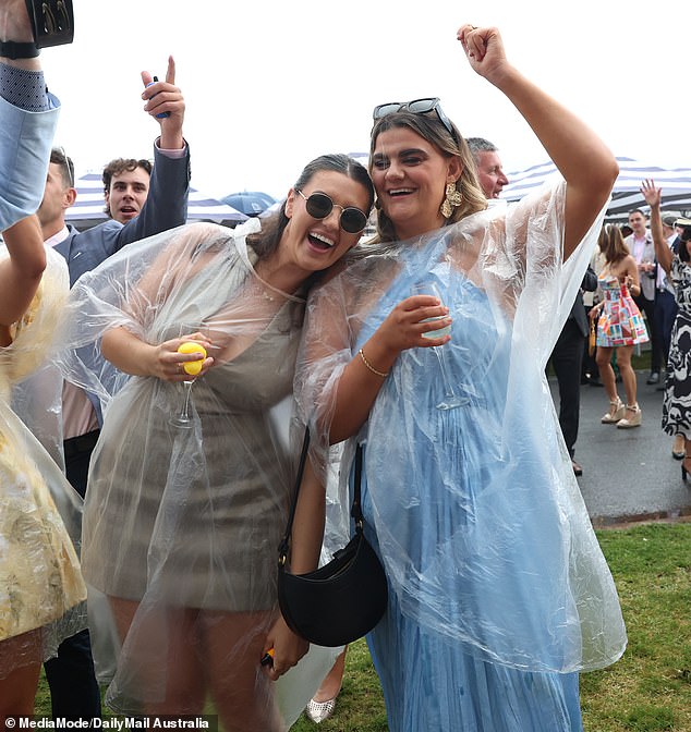 Everyone smiles! Thousands of revelers made the most of the day at the Oaks, despite the poor weather.