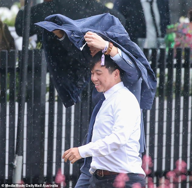 Who needs an umbrella? Several attendees got creative once the rain started pouring.