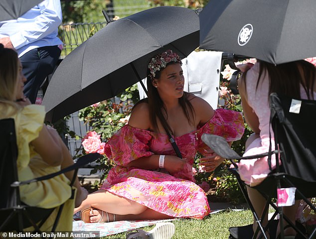 Revelers who remembered to bring an umbrella were grateful as rain spread across Flemington on Thursday afternoon.