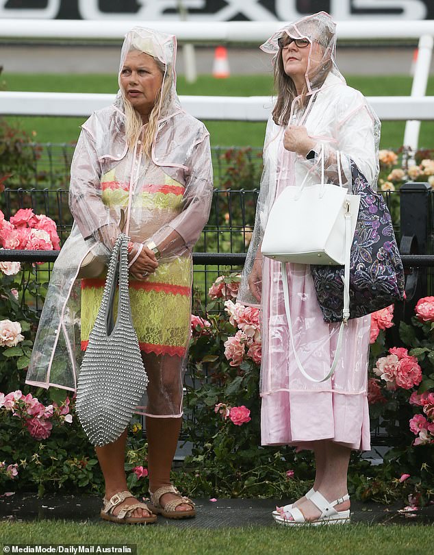 Well-prepared racegoers brought umbrellas and raincoats.