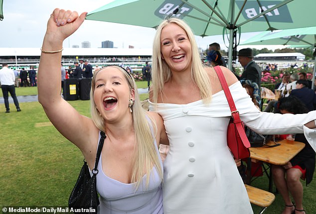 Crown Oaks Day attendees were all smiles despite the bad weather