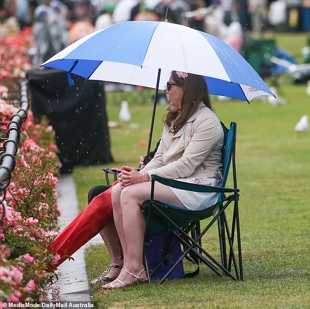 Prepared attendees were able to enjoy the racing on the track while others were forced to hide from the rain under cover.