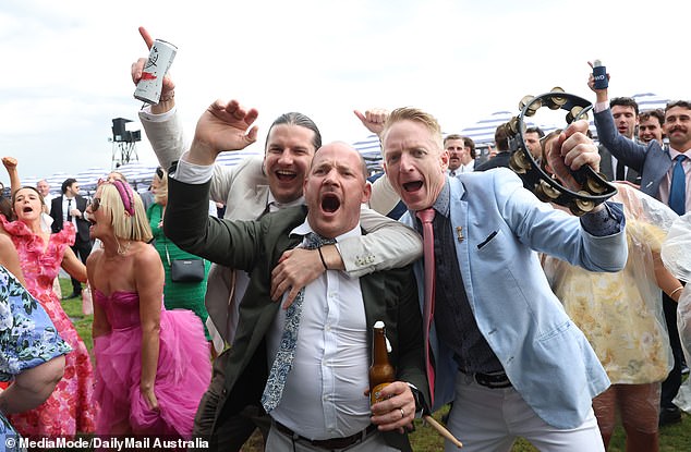 The winners smile! Dancing revelers weren't worried about the grass turning to mud Thursday.