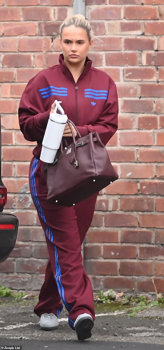 Molly was seen carrying her belongings in her eye-catching £25,000 burgundy Hermes Birkin bag and also carried a large white Stanley mug.