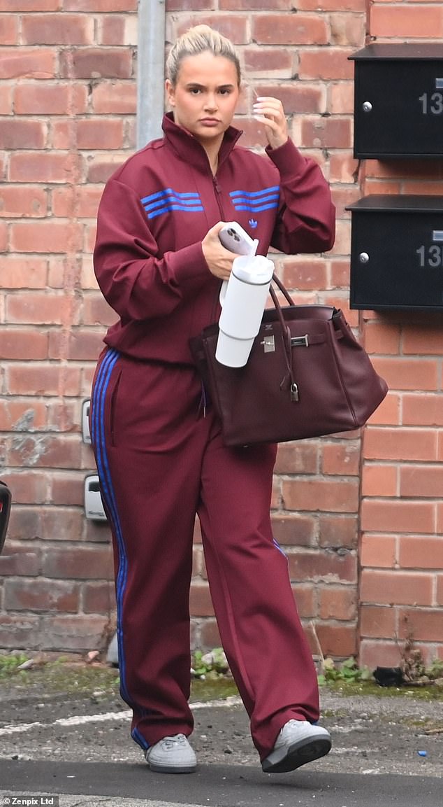 Molly was seen carrying her belongings in her eye-catching £25k burgundy Birkin bag and was also carrying a large white Stanley mug.