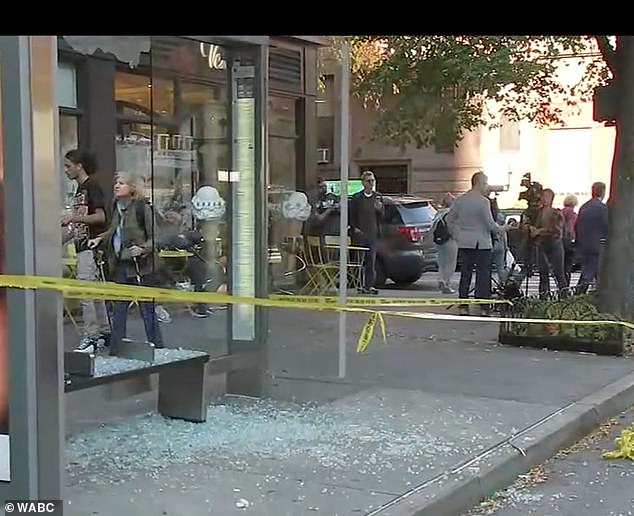 Images from the scene show shards of broken glass on the street near a bus stop.