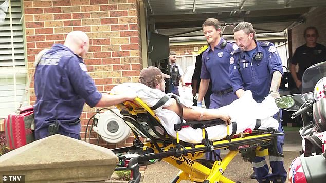 Police officers helped the NSW Ambulance crew get the man off the roof where he had been working.