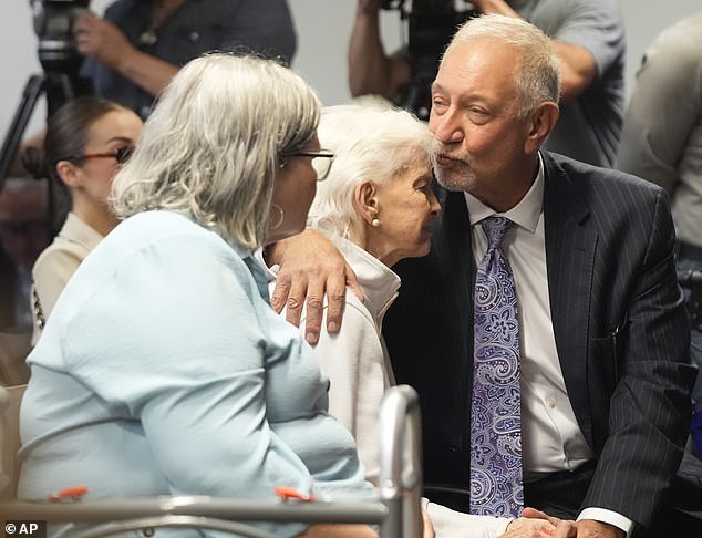 Kitty Menendez's sister, Joan Andersen VanderMolen (center), is greeted by defense attorney Mark Geragos at a news conference last month.