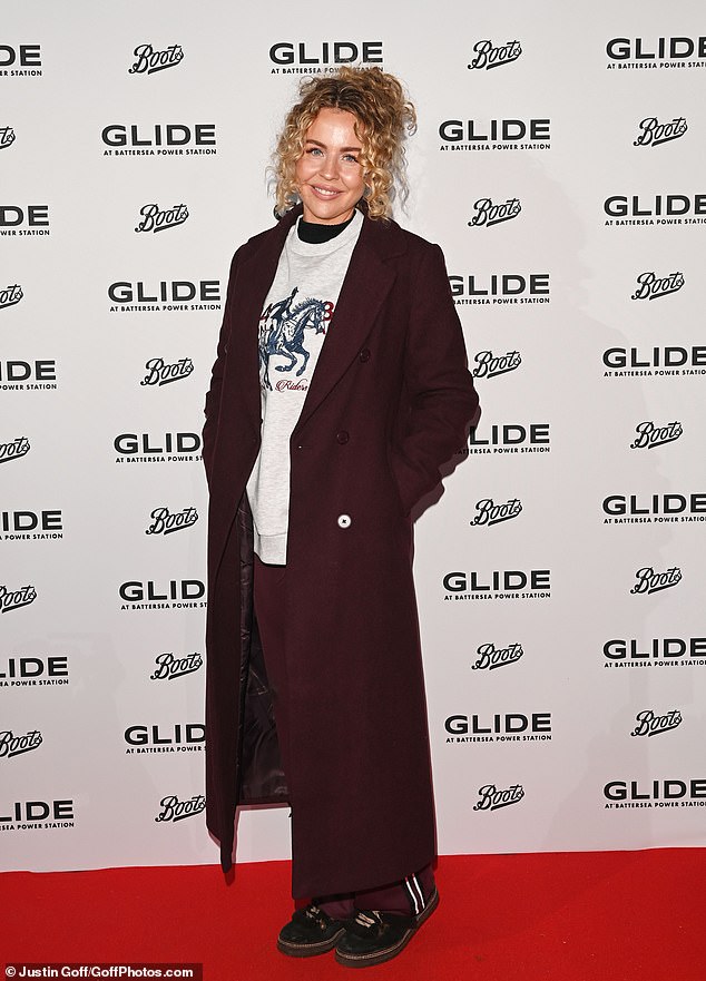 TOWIE's Lydia Bright looked comfortable in a pair of maroon tracksuit bottoms, an oversized white jumper and a matching maroon coat.