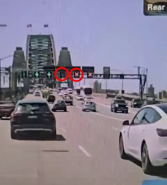 Red crosses and green markings (circled in red) indicate which lanes are available to drivers traveling north and southbound on the Sydney Harbor Bridge.