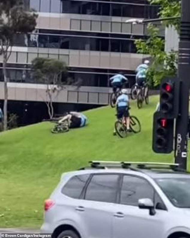 Eight New South Wales police officers were cycling up a steep slope in Sydney when one of them began to lose his balance and tripped (pictured)