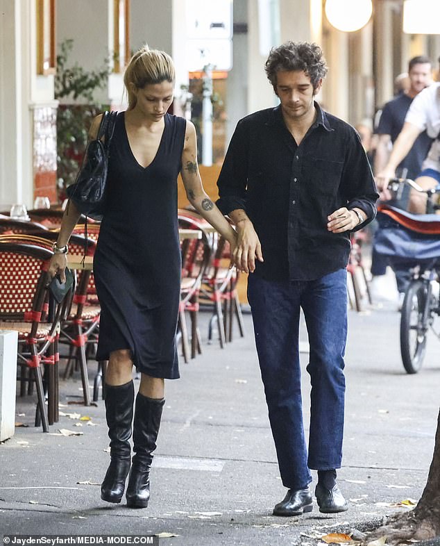 The couple held hands as they walked down the bustling street.