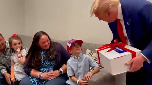 Liam met his hero in person during a rally where Trump arrived with gifts: a red bow-wrapped box filled with MAGA goodies.