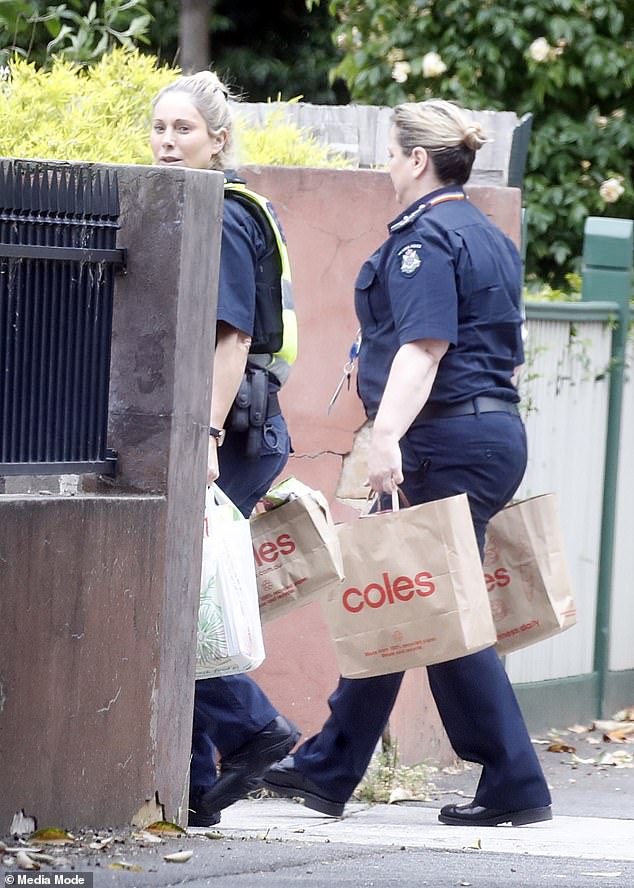 Arrested: Victoria Police officer sees Daily Mail Australia photographer capturing his grocery delivery