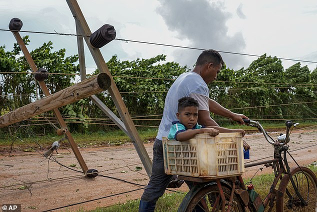 Rafael moved away from Cuba on Thursday and entered the Gulf of Mexico as a Category 2 hurricane, leaving behind damaged homes, uprooted trees and downed telephone poles.