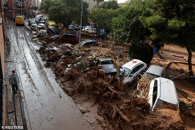 Damaged cars and debris on the side of a road, following heavy rain that caused flooding, in Paiporta, near Valencia, Spain, on November 6, 2024.