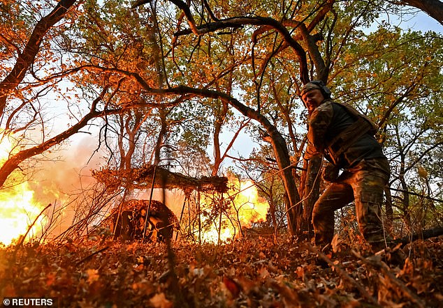 A Ukrainian service member of the Hyzhak (Predator) special police unit fires a D30 howitzer toward Russian troops, amid Russia's attack on Ukraine, near the border town of Toretsk, Ukraine, on October 25, 2024.