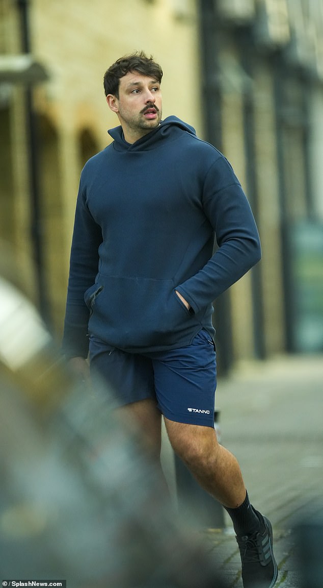 Georges followed in a navy blue hoodie and matching shorts.