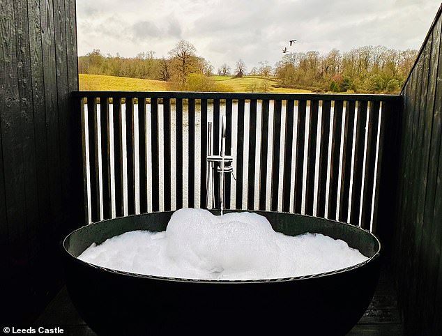 Enjoying the view from an open-air bathroom at her hostel, pictured, Laura wonders 